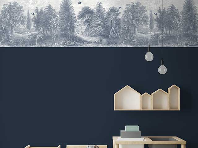 Dark blue wall with a matching forest-themed border at the top - Goodhomesmagazine.com
