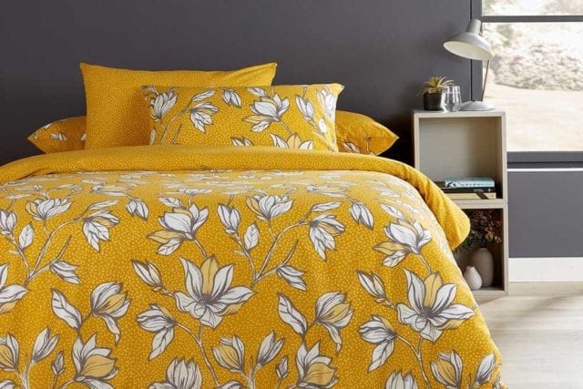 Ochre bedding with a polka dot background and a cream and white flower print - Bold bedding - Goodhomesmagazine.com