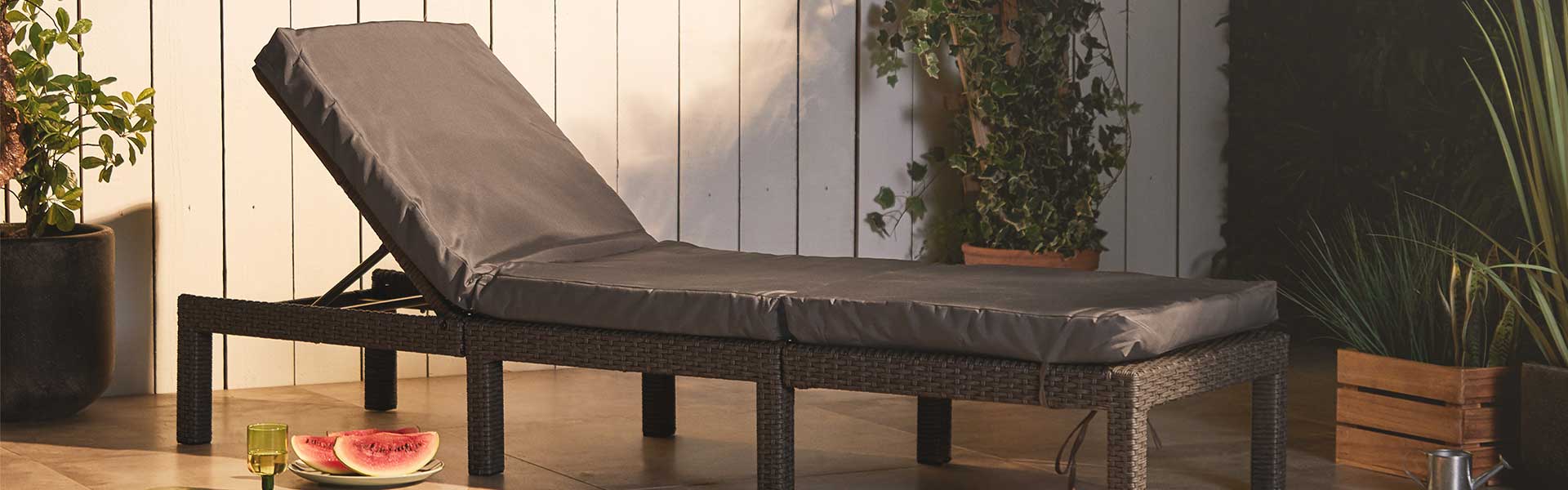 Black rattan sun lounger on the patio - 2021 garden furniture - Goodhomesmagazine.com