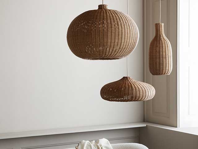 Three different shaped rattan lampshades hanging from the ceiling of a room painted in neutral tones - Rattan - Goodhomesmagazine.com