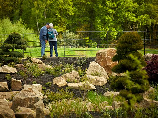 Two people on a bridge in a picturesque garden - UK days out - Goodhomesmagazine.com