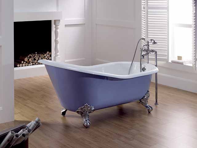 Freestanding purple bath tub in empty room, goodhomesmagazine.com