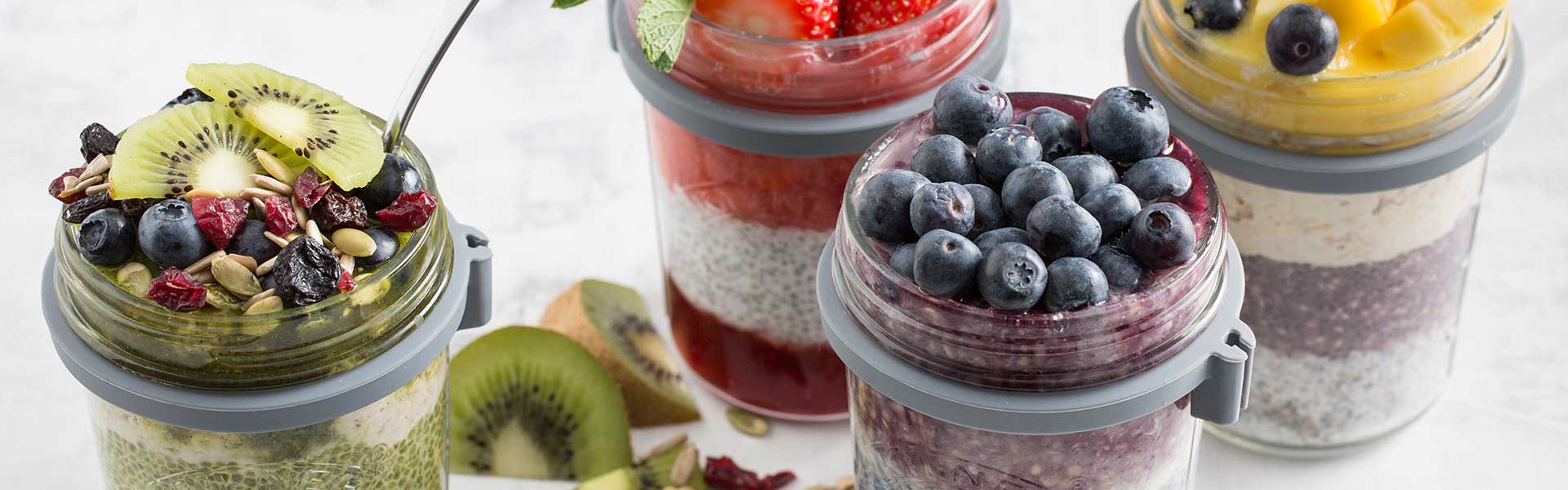 Glass jars filled with layers of yoghurt, compote, and fruit - Summer kitchen essentials - Goodhomesmagazine.com