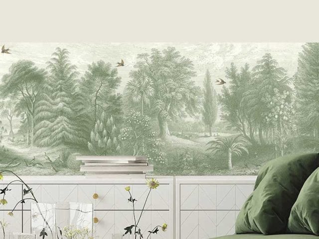A beige painted room with a plush green velvet sofa, and a green wallpaper border - Woodchip & Magnolia - Goodhomesmagazine.com