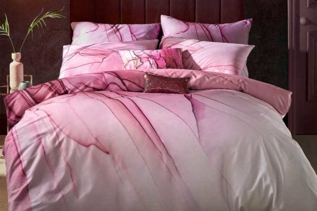 Double bed with bedding set that has a pink marble pattern - Bold bedding - Goodhomesmagazine.com