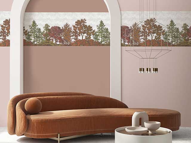 Brown sofa in front of a pink-toned wall with a complementary border - Goodhomesmagazine.com