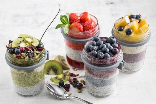 Four clear jars each filled with layers of fruit, yoghurt, and compote - Kitchen gadgets - Goodhomesmagazine.com