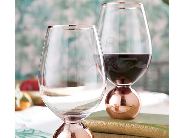 rose gold glass on table with floral background, goodhomesmagazine.com