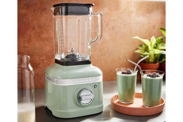 Retro style mint green blender on a worktop next to two glasses filled with green smoothie - Kitchen gadgets - Goodhomesmagazine.com