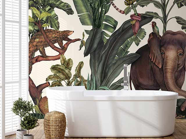 A bathroom with a vivid jungle print mural featuring a large elephant on the wall - Instagram wallpaper trends - Goodhomesmagazine.com