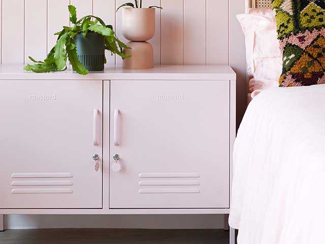 Blush pink metal locker next to a bed - Metal storage lockers - Goodhomesmagazine.com