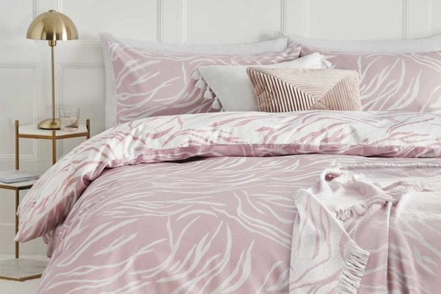 Blush pink bedding with a white zebra stripe print - Bold bedding - Goodhomesmagazine.com