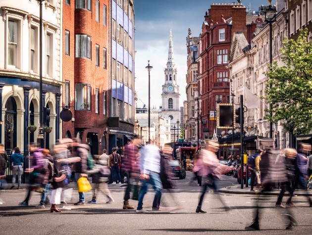 people crossing the road on a busy street