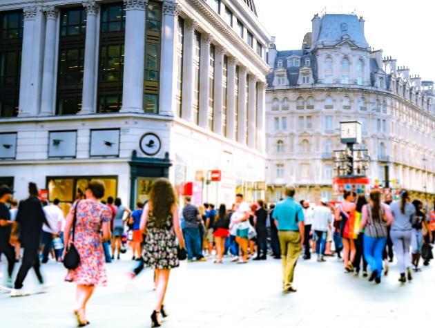 people walking in a sunlit square