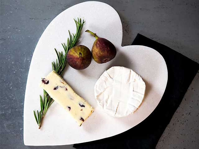 Heart shaped marble serving platter with some cheeses on it - BBQ week essentials - Goodhomesmagazine.com
