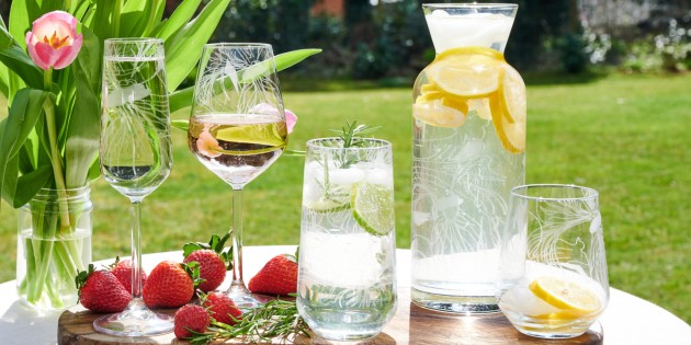 table in a garden with assorted glasses and decanters