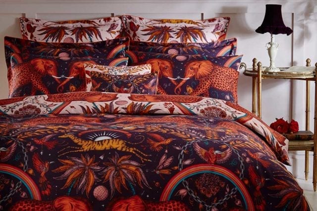 A bedding set in wine and blush with an eclectic collection of birds, elephants, palm trees and more - Bold bedding - Goodhomesmagazine.com