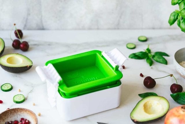 A white and green tofu press contraption surrounded my miscellaneous vegetables - Kitchen gadgets - Goodhomesmagazine.com