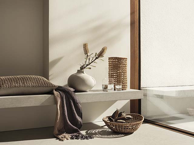 Mantel ledge with cushion, vase, and handwoven baskets, goodhomesmagazine.com