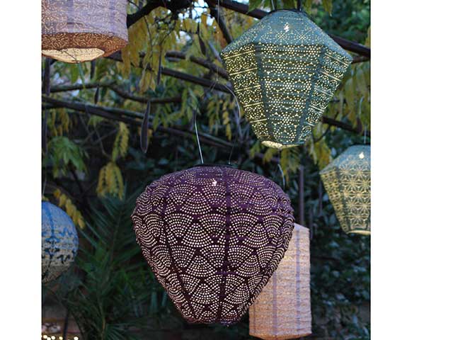 Bohemian floating lanterns hanging from trees, goodhomesmagazine.com