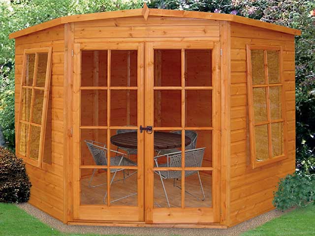 small wooden summerhouse with a pentagon roof and shiplap exterior 