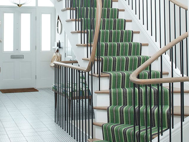 Stripped green runner rug on hallway stairs by Roger Oates Designs