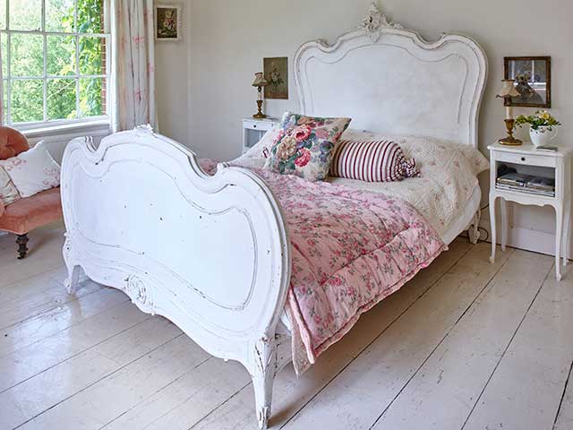 Metal framed antique bed in master room