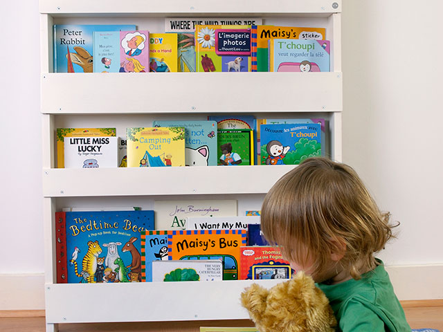 Book shelves storing colourful books for little girl