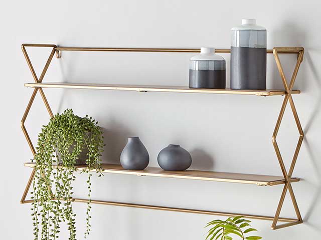 Copper geometric stylish shelfies with two layers, decorated with hanging plants, small ornaments and candles, goodhomesmagazine.com