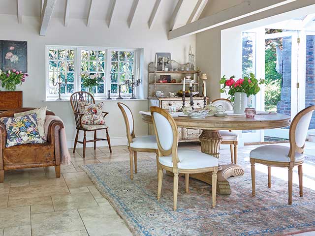 Dining room wiith tiled flooring and antique chairs