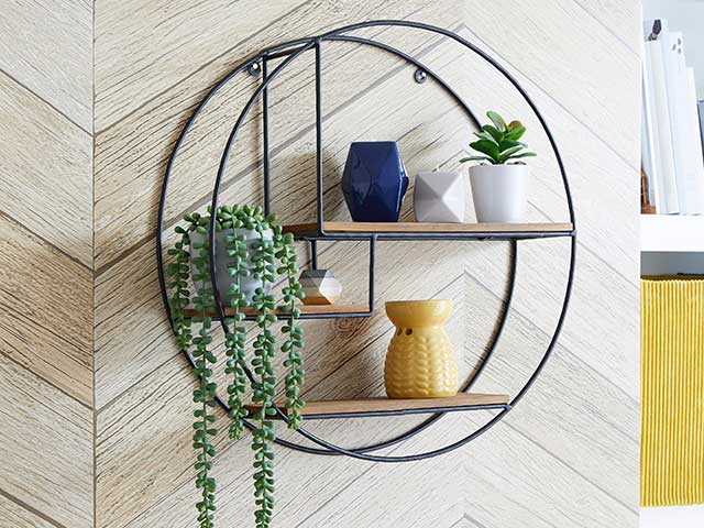 Circular shelf storing succulants, mini vases, wax melts and hanging plant, goodhomesmagazine.com