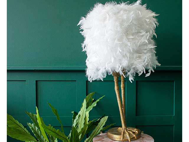 White feathery lamp shade with gold birds legs feet on a gold side table - Living room lighting - Goodhomesmagazine.com