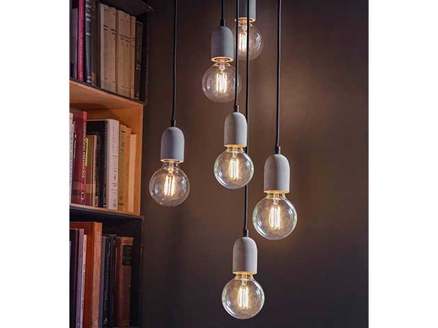 6 industrial-inspired cement pendant lights with large filament bulbs hanging from the ceiling - Living room lighting - Goodhomesmagazine.com