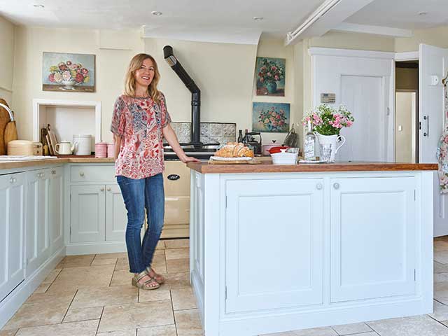 Kithen with powder blue units and island overlooking large garden