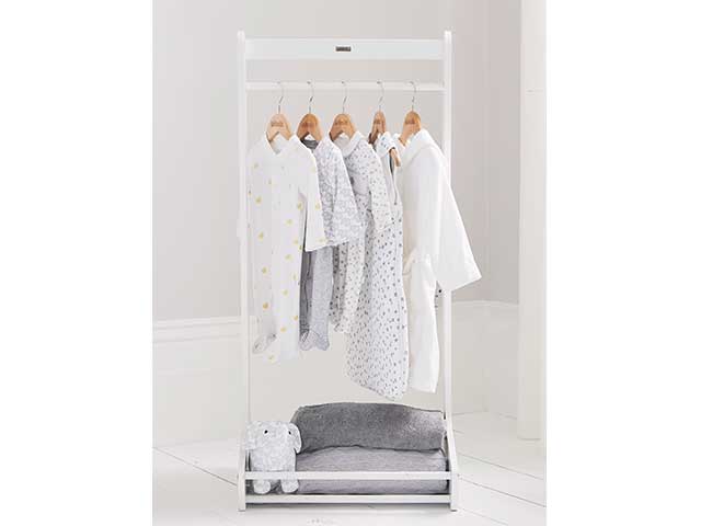 Small white clothes rail with clothes hanging from wooden hangers - Children's bedroom furniture - Goodhomesmagazine.com
