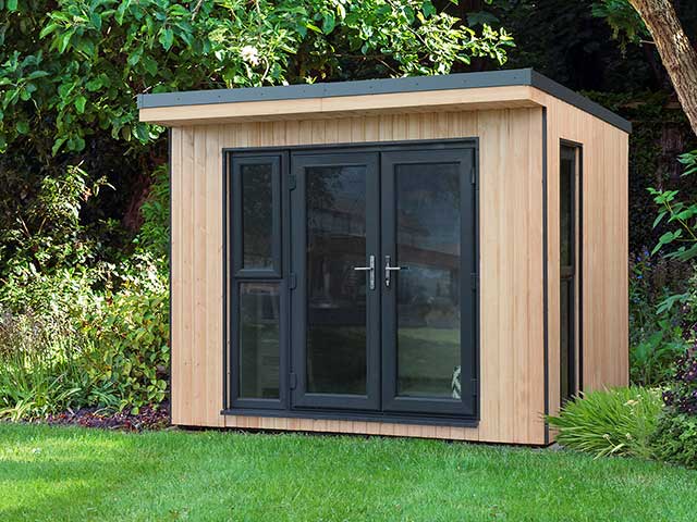 Stylish garden building in light wood and black glass doors and windows