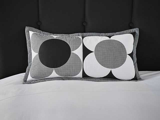 Monochrom flower black and white cushions on black pincushion headboard and white bedding