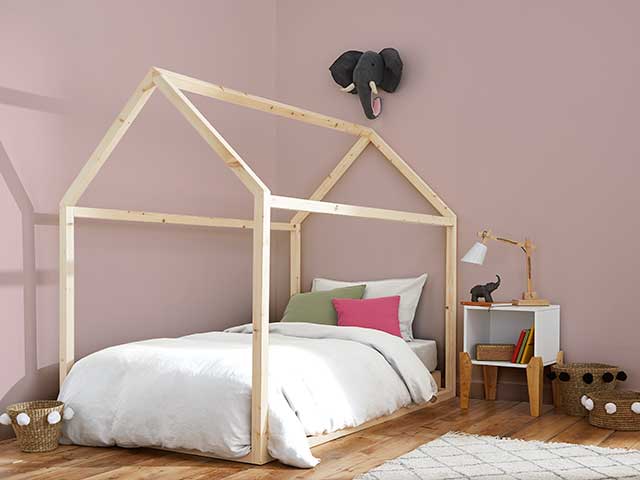 pink room with elephant hanging and wooden framed bed inspired by Stacey Solomon's pink nursery