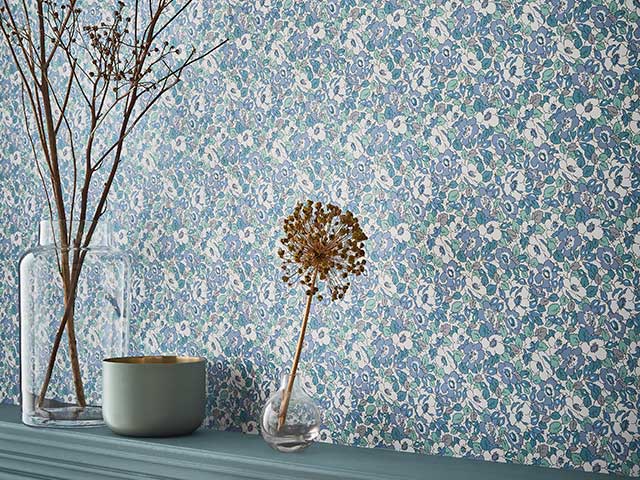 Nancy Rose Dunelm Dorma Decades collection wallpaper with plants on mantlepiece