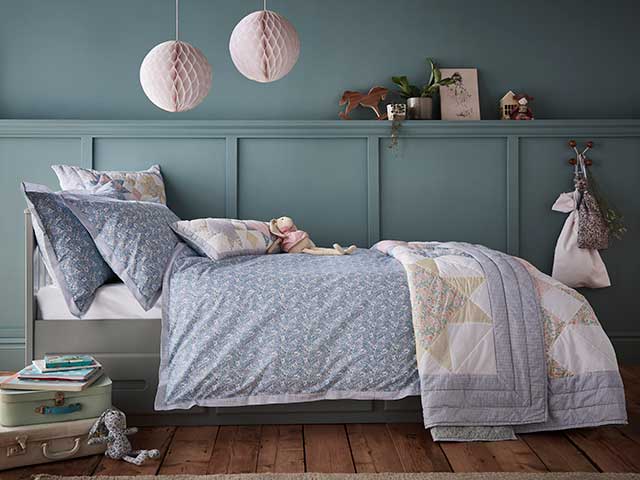 Children's bedroom in Nancy Rose Dunelm Dorma Decades collection with pink floating lanterns