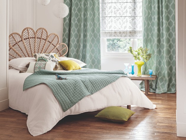 bedroom with wooden flooring and green curtains