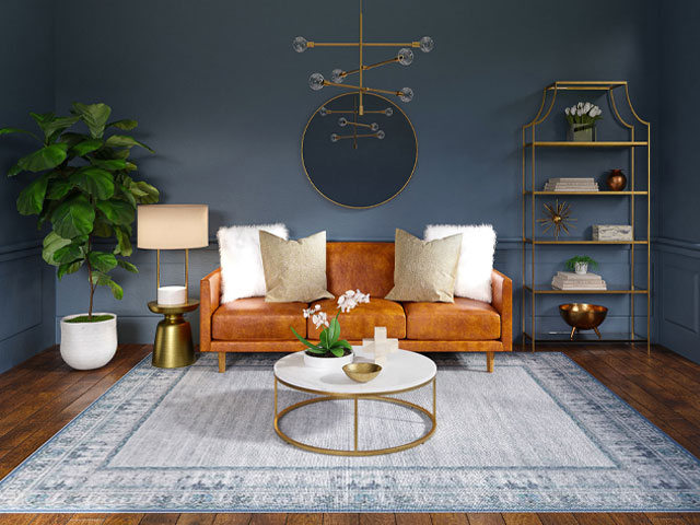 Interior designed living room with tan leather sofa and dark walls