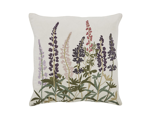 Hand embroidered floral cushion on white background