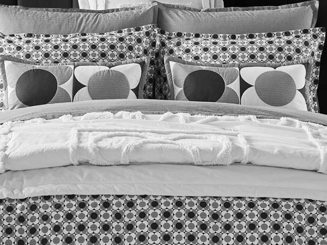 Monochrome bedding on double bed with scatter cushions