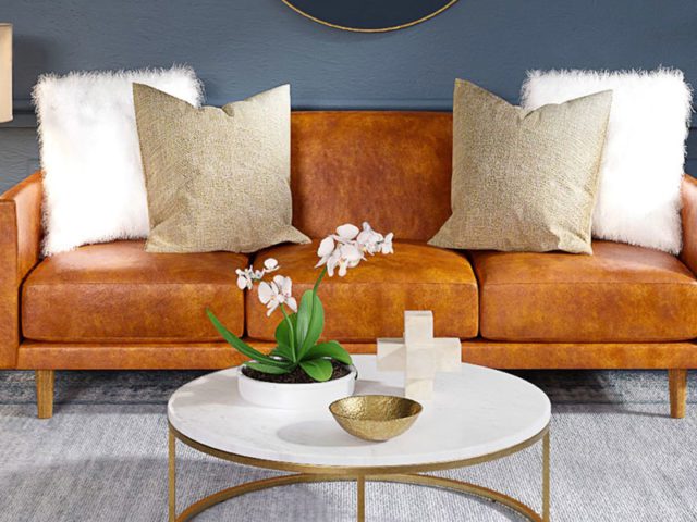 Interior designed living room with tan leather sofa and dark walls