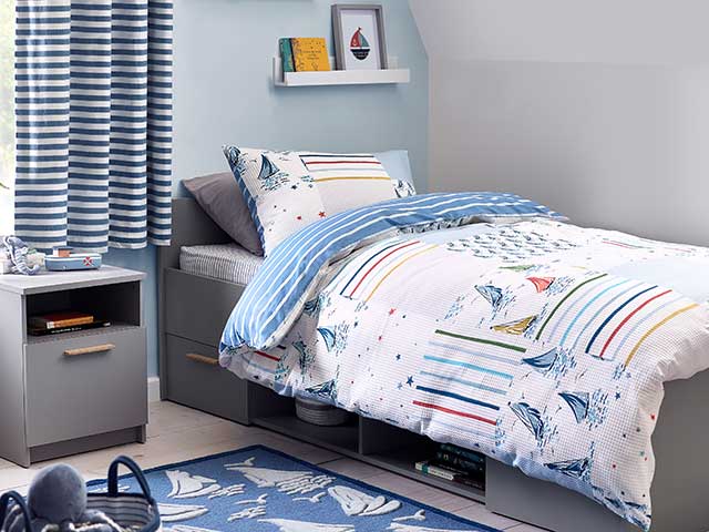 Nautical children's nursery with rug and bedding