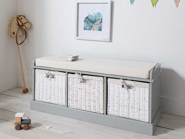 White baskets on circular unit in nursery space