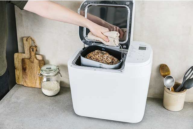 White bread makers with loose ingredients on marble worktop