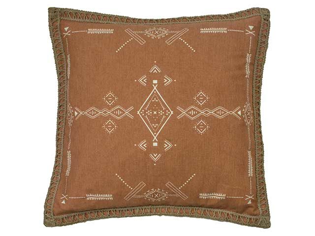 Brown cushion with goblincore background on white background