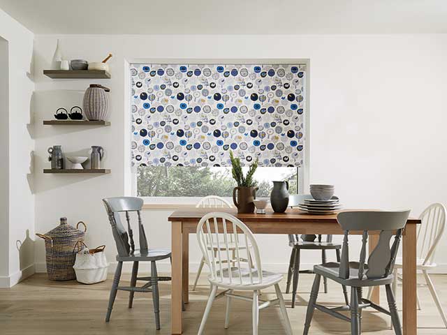 Dining room with blue and grey patterned roller blinds